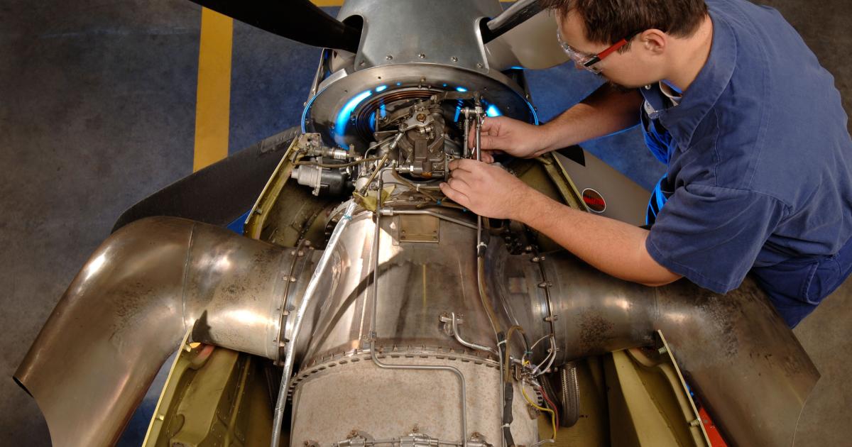 A technician performs MRO activity on a PT6A engine.