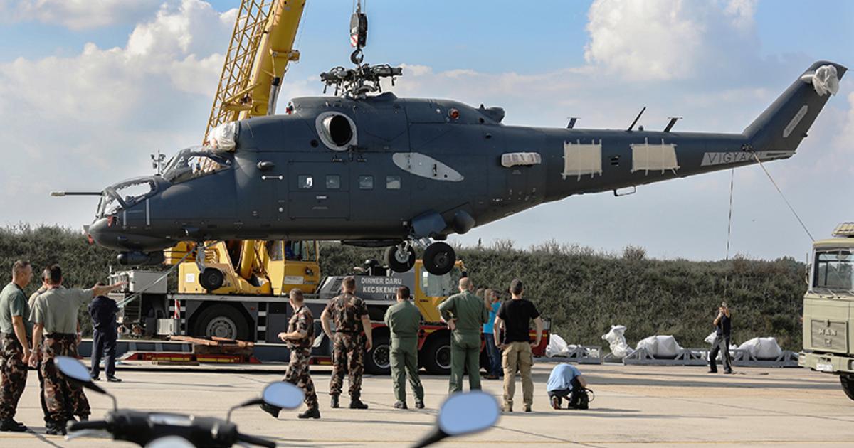 Fresh from overhaul in Russia, a Hungarian Mi-24 is craned aboard a low-loader for delivery to its base at Szolnok. (photo: courtesy of honvedelem.hu)