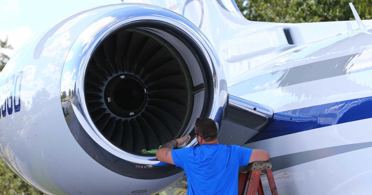 A cleaning crew member puts the finishing touches on this Rolls-Royce turbofan during setup at Gulfstream’s static-display in advance of the 2018 edition of NBAA-BACE.