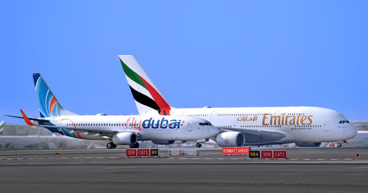 A Flydubai Boeing 737 and Emirates Airbus A380 prepare for takeoff at Dubai International Airport. The two airlines have expanded their code-share arrangement to cover some 100 destinations. 