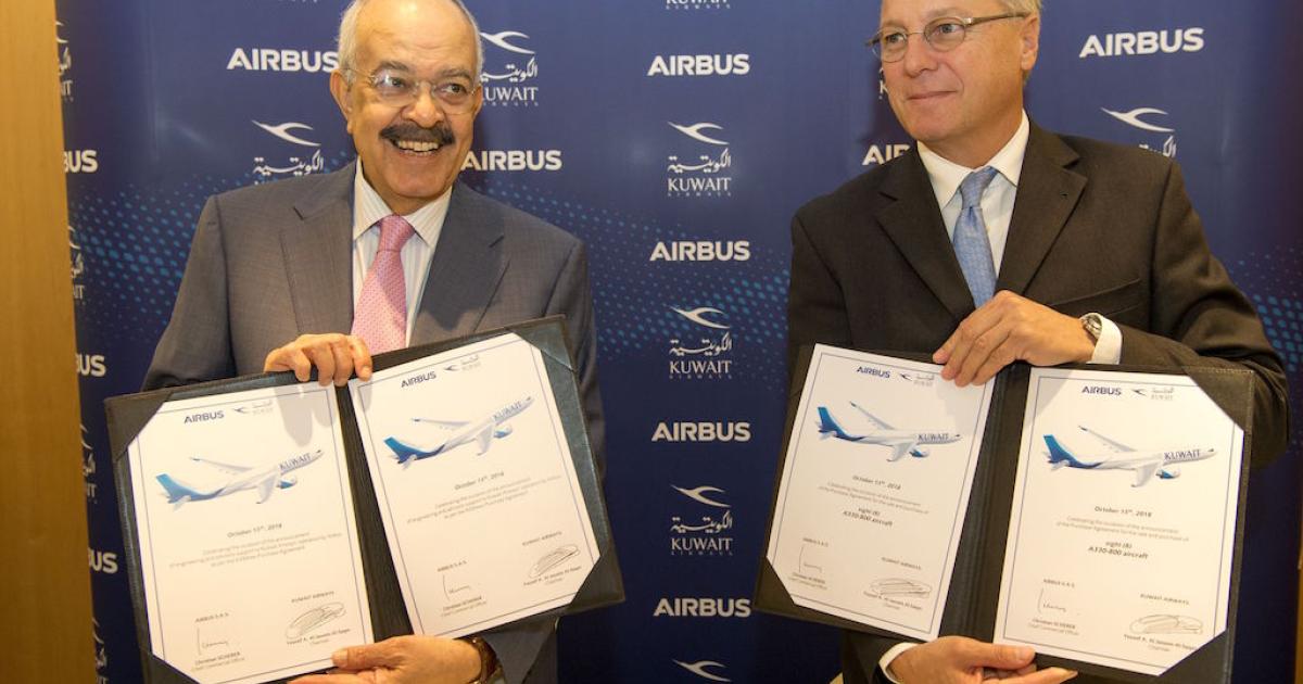 Kuwait Airways chairman Yousef Al-Jassim (left) and Airbus chief commercial officer Christian Scherer commemorate the signing of a purchase agreement for eight A330-800s in Toulouse. 