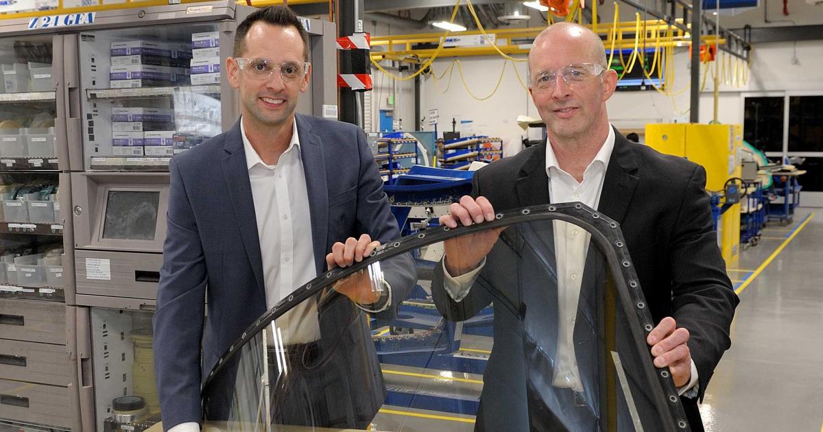 (l-r) Steve Kight, global director for general aviation transparencies with PPG Aerospace, and Mark Hood,
plant manager for the company's Sylmar, Calif. transparencies facility, show off PPG's  aftermarket windshield for the Beechjet 400 business jet and its variants.