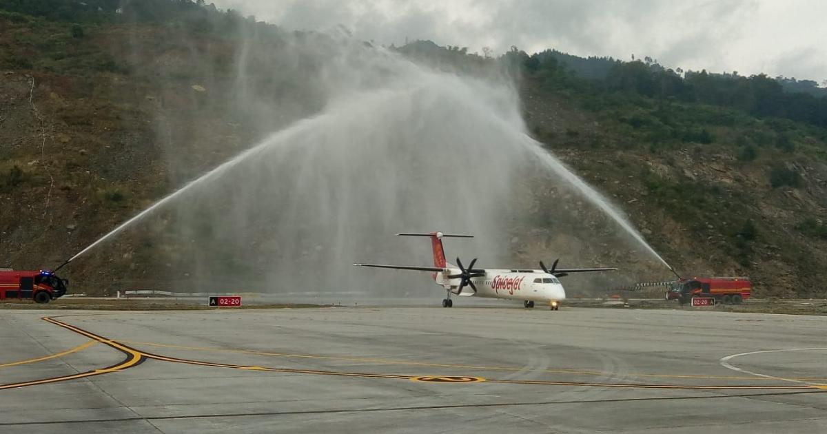 A SpiceJet Bombardier Q400 gets a water cannon welcome at India's new Pakyong Airport, near the Chinese border. 