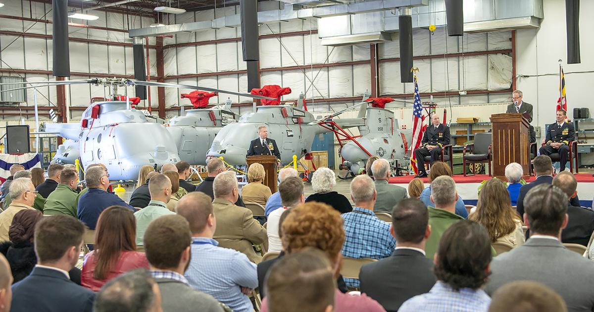 Four MQ-8Cs and a single MQ-8B form the backdrop to UX-24's commissioning ceremony. (photo: U.S. Navy)