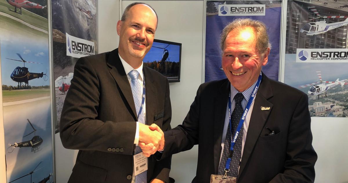 Dennis Martin, the Enstrom Corporation’s director of sales and marketing (left) and François Gatineau, CEO of Rotor & Aircraft Sarl, celebrate the deal.