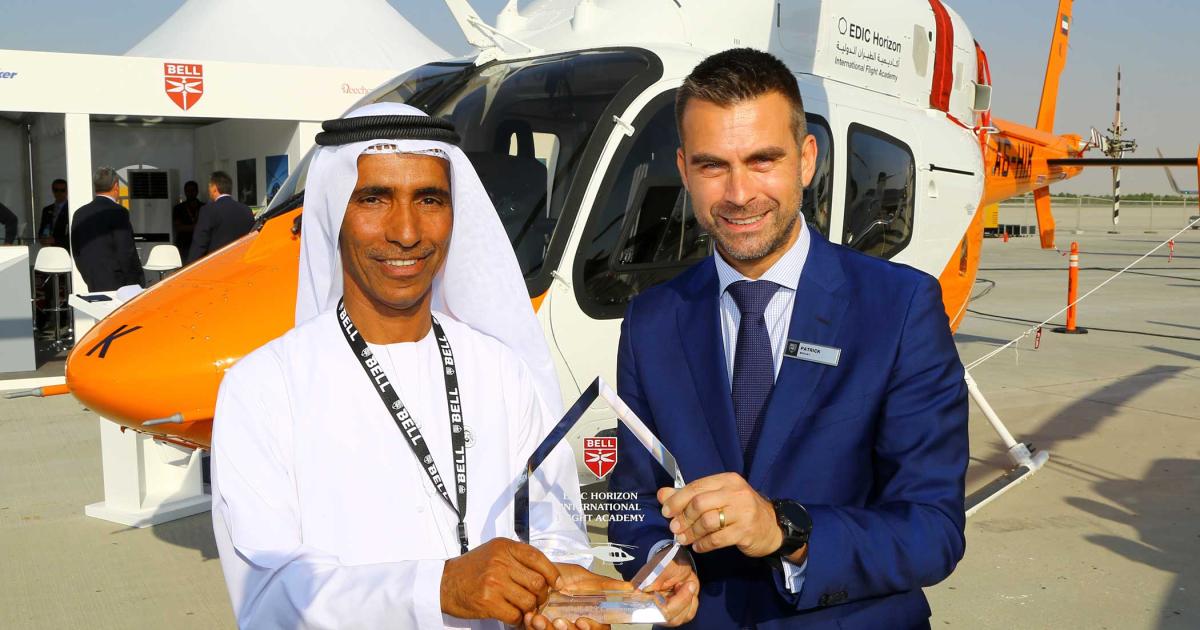 Hareb Thani Al Dhaheri, EDIC Horizon Flight Academy CEO (l) and Patrick Moulay, Bell Helicopter’s executive v-p for commercial sales and marketing, celebrate their business relationship after two new Model 429s were delivered yesterday at MEBAA 2018.