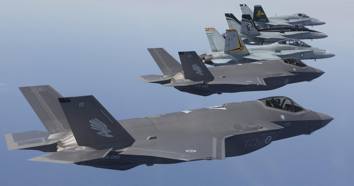 No. 3 Squadron's bomb-carrying eagle badge adorns the fins of the unit's first two F-35As, seen here with F/A-18As from Nos 75 and 77 Squadrons and an F/A-18B from 2 OCU. (photo: Commonwealth of Australia, Department of Defence)