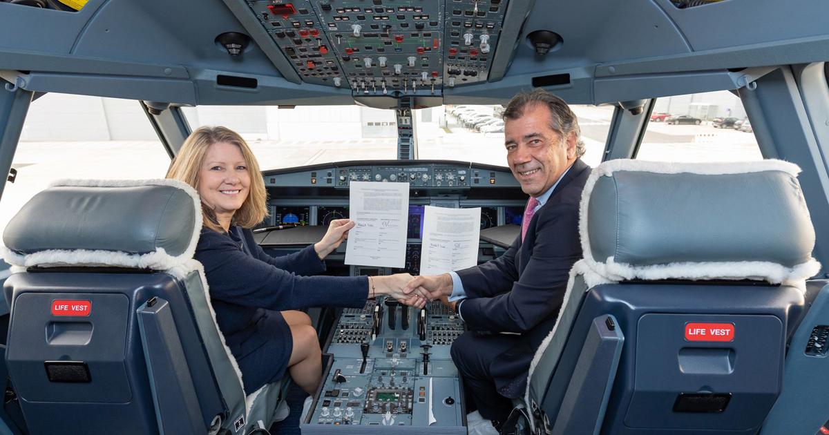Michele Evans, executive vice president, Lockheed Martin Aeronautics, and Fernando Alonso, head of military aircraft at Airbus Defence and Space, shake hands on the new agreement on the flight deck of an A330 MRTT. (Photo: Airbus)
