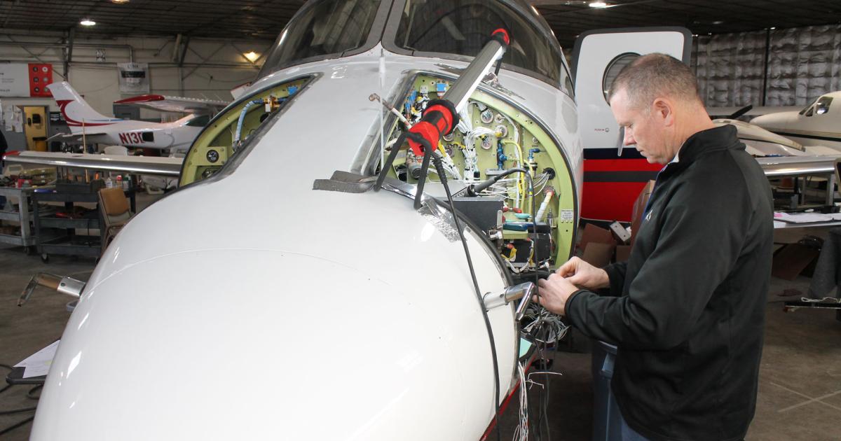 Avionics technician Scott Merchant works on a Beechjet 400A/Hawker 400 at Bevan-Rabell in Wichita, which effective January 1 is changing its name to Bevan Aviation to reflect its growing work on light twinjets. (Photo: Jerry Sienbenmark/AIN)