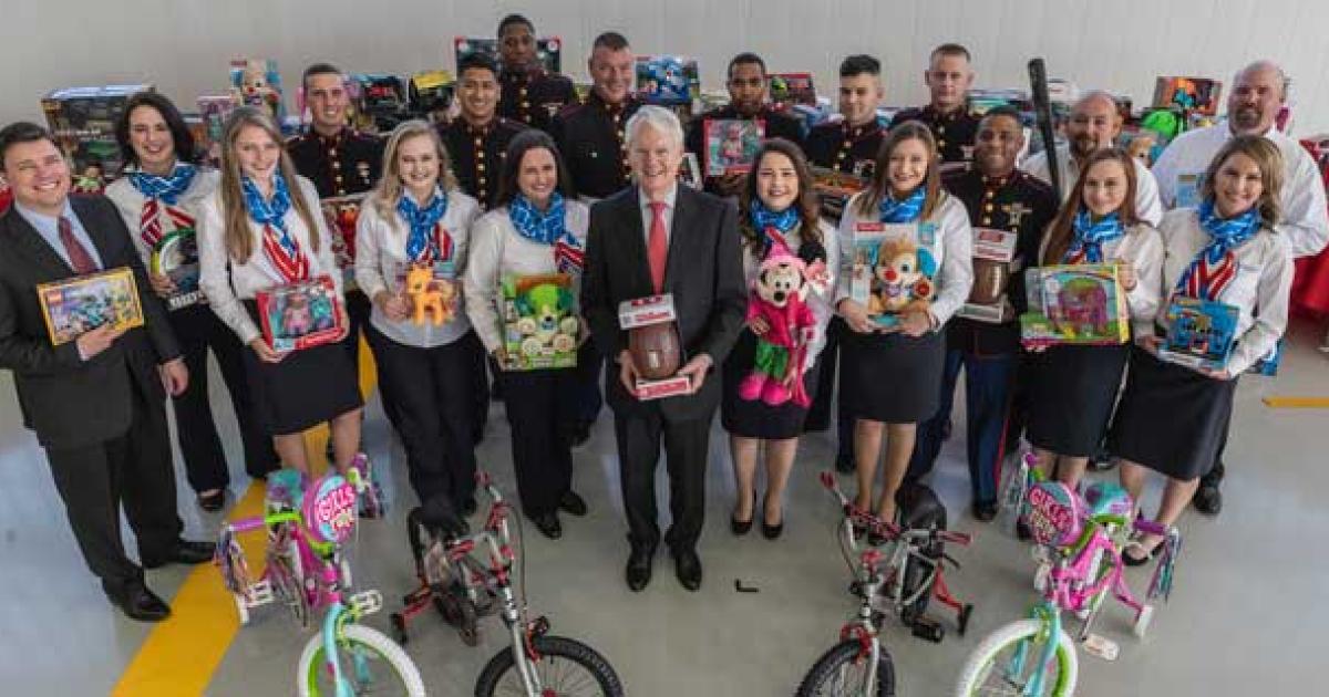 American Aero FTW owner Robert Bass (center) and the FBO's staff collected hundreds of gifts in support of the U.S. Marine Corps Toys-for-Tots program. The company donated another 50 bicycles this year, bringing its tally over the past six years to 550.
