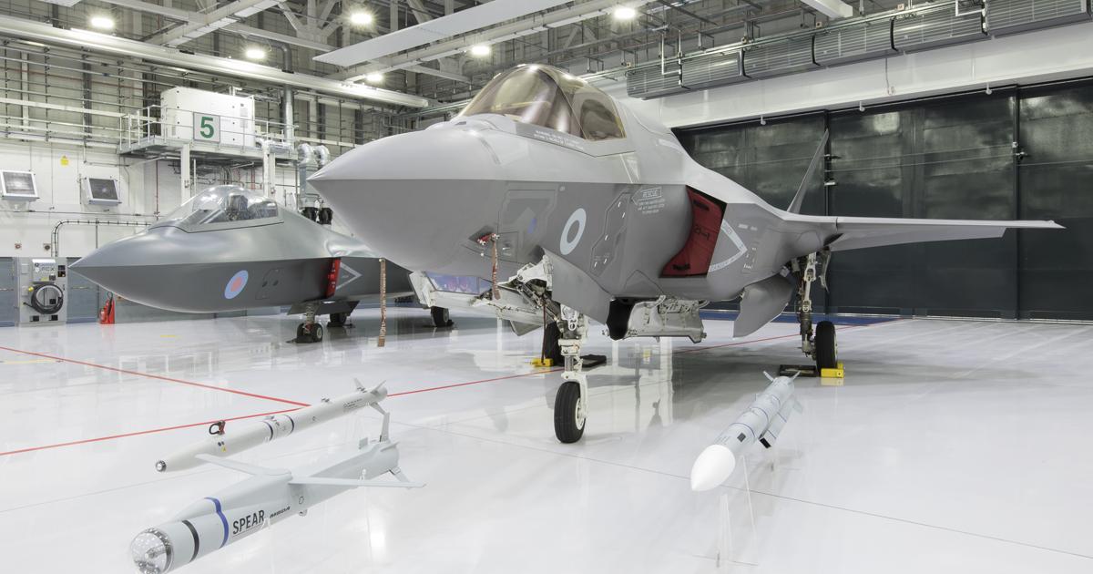 An F-35B is displayed with Spear, ASRAAM and Meteor missiles, with the Tempest mock-up in the background. (photo: RAF Marham)