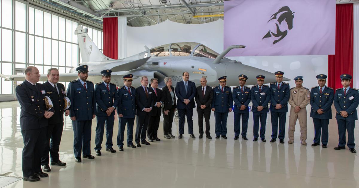 VIPs from Qatar and France pose in front of the first Rafale to be handed over. The stylised Arab stallion graphic is the badge of the new Rafale squadron. (Photo: Dassault Aviation)