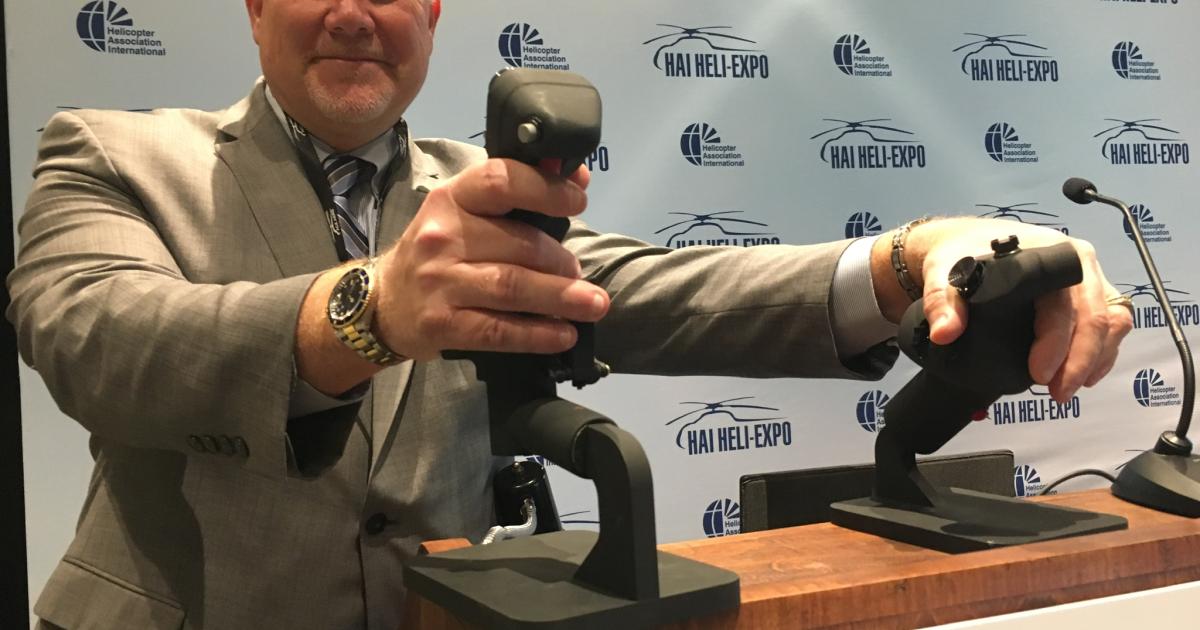 Robert Hole demonstrates prototype 3D-printed Essex ergonometric collective and cyclic grips for helicopters that Essex Industries is developing for the Sikorsky BlackHawk.