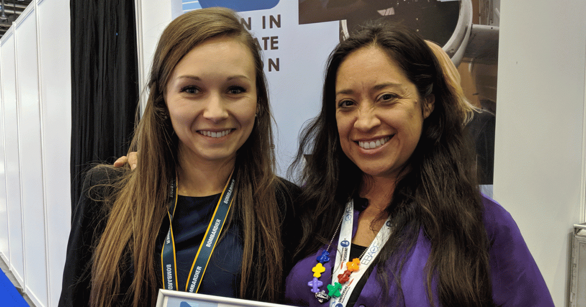 Alexandra Chorazka, left, a flight attendant based in Poland, received a scholarship award from Andrea Prisca Garcia, chair of the Women in Corporate Aviation scholarship committee.