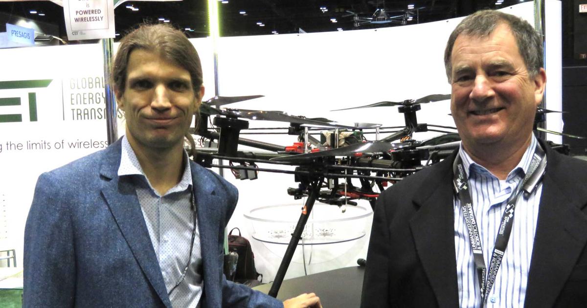 GET's Sergey Plekhanov (left) and William Kallman with a drone modified to charge from the company's "power cloud." (photo: Mark Huber)