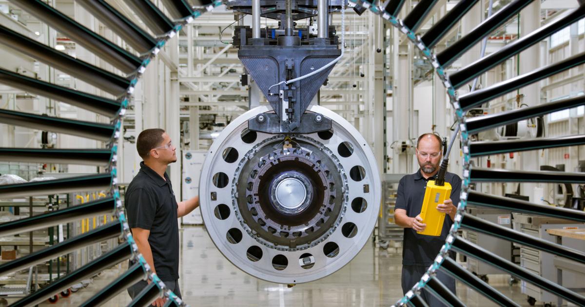 Workers inspect components of a geared turbofan engine at P&W’s Florida-based engine center.