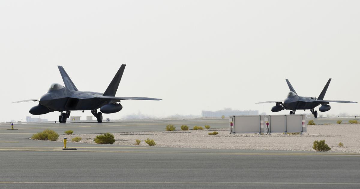 Fitted with external tanks, a pair of F-22As taxis in at Al Udeid following deployment from the U.S. The photo has been "edited for security reasons"—presumably to remove unit codes—although it is known that the aircraft came from Langley. (Photo: AFCENT)