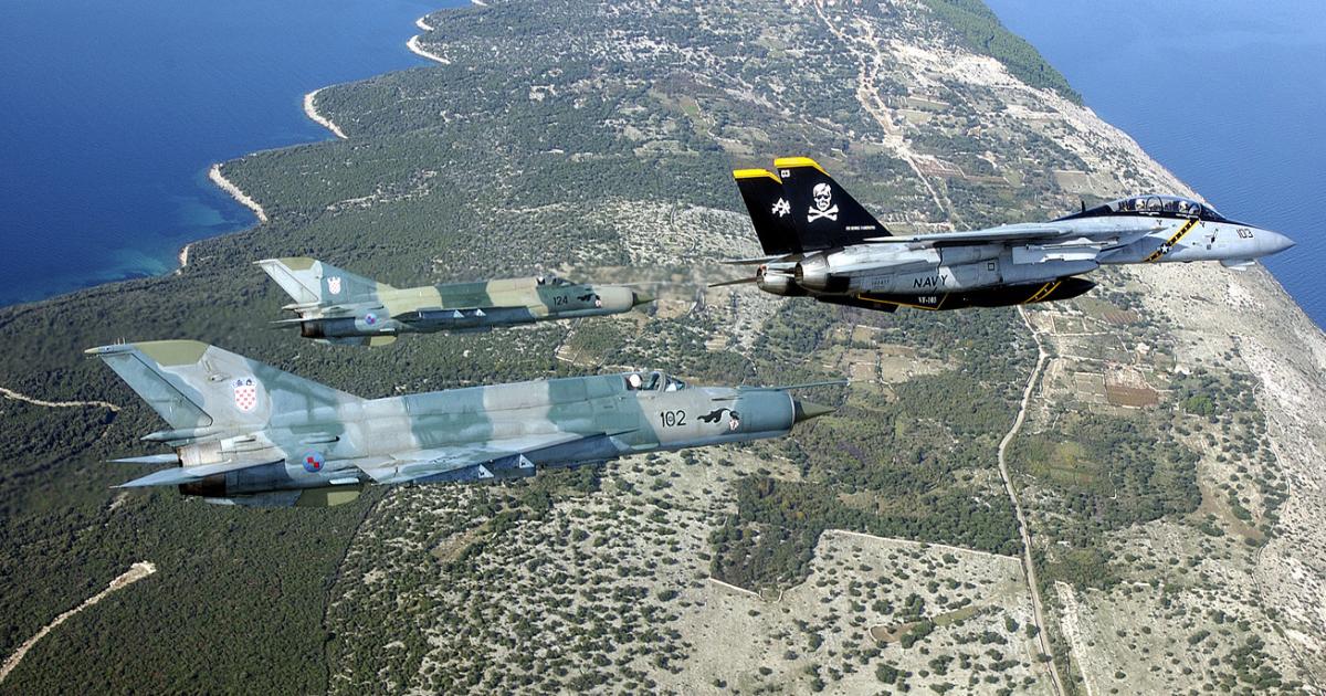 Two Croatian MiG-21bis fighters exercise with a VF-103 "Jolly Rogers" F-14B Tomcat during the early 2000s. Although the elderly MiGs have been made NATO-compatible, they are sorely in need of replacement. (photo: U.S. Navy)