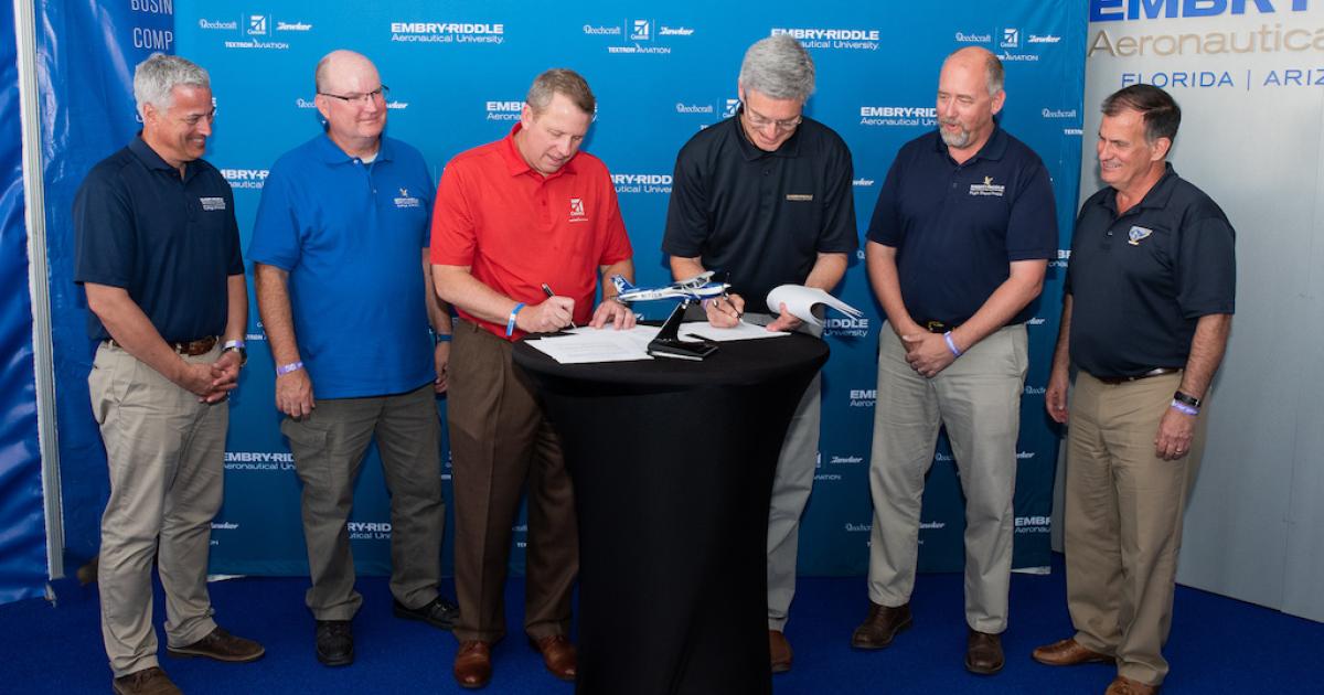 From left, deans of Embry-Riddle’s Colleges of Aviation in Prescott, Arizona, and Daytona Beach, Florida, Timothy Holt and  Alan Stolzer watch as Textron Aviation president and CEO Ron Draper and Embry-Riddle president Dr. P. Barry Butler sign a memorandum of understanding for the purchase of at least 60 Cessna Skyhawks. Standing to the right of Butler are Embry-Riddle flight department chairs Kenneth Byrnes and Parker Northrup. (Photo: Textron Aviation)