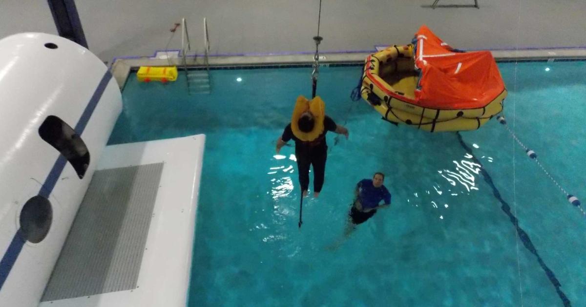 The Executive Emergency Training course at FlightSafety International's Teterboro location features water evacuation instruction in the facility's pool. Here, helicopter rescue hoist equipment and lift techniques are being demonstrated on the author. (Photo Judylyn LaGuardia)