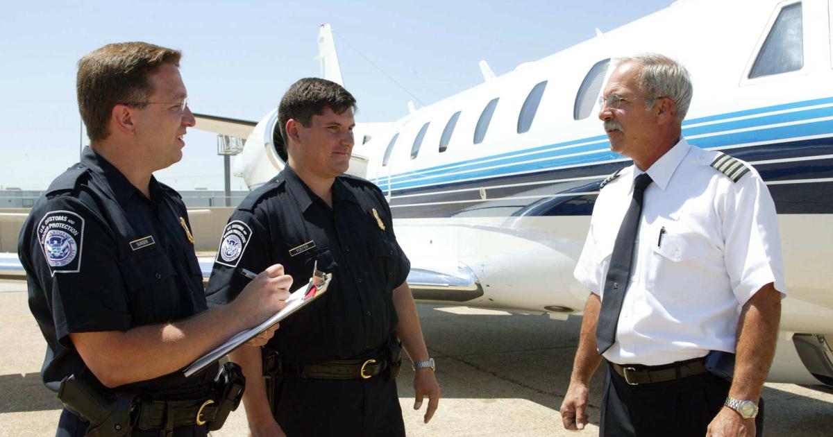 CBP officers conduct a routine interview with the pilot of a business aviation flight.