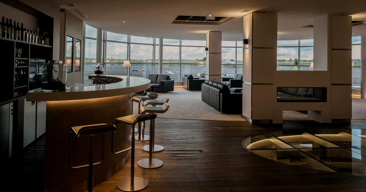 The expansive passenger lobby at Astonfly's new FBO at Paris Le Bourget features a bar area, fireplace and uniquely, a 3,000 bottle wine cellar embedded in the floor, with a see-through glass top. (Photo: Astonfly/Aurelia Blanc)