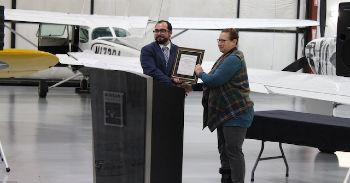 Jeremy Rangel, Duncan Aviation airframe manager, accepts the official registration document for its apprenticeship program from Deb Creemens-Risinger of the U.S. Department of Labor. (Photo: Duncan Aviation)