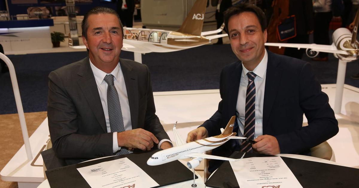 Airbus Corporate Jets president Benoit Defforge, left, and Daniel Soltani, sr v-p of sales and business development for Sabena Technics, inked a new agreement at NBAA 2019.