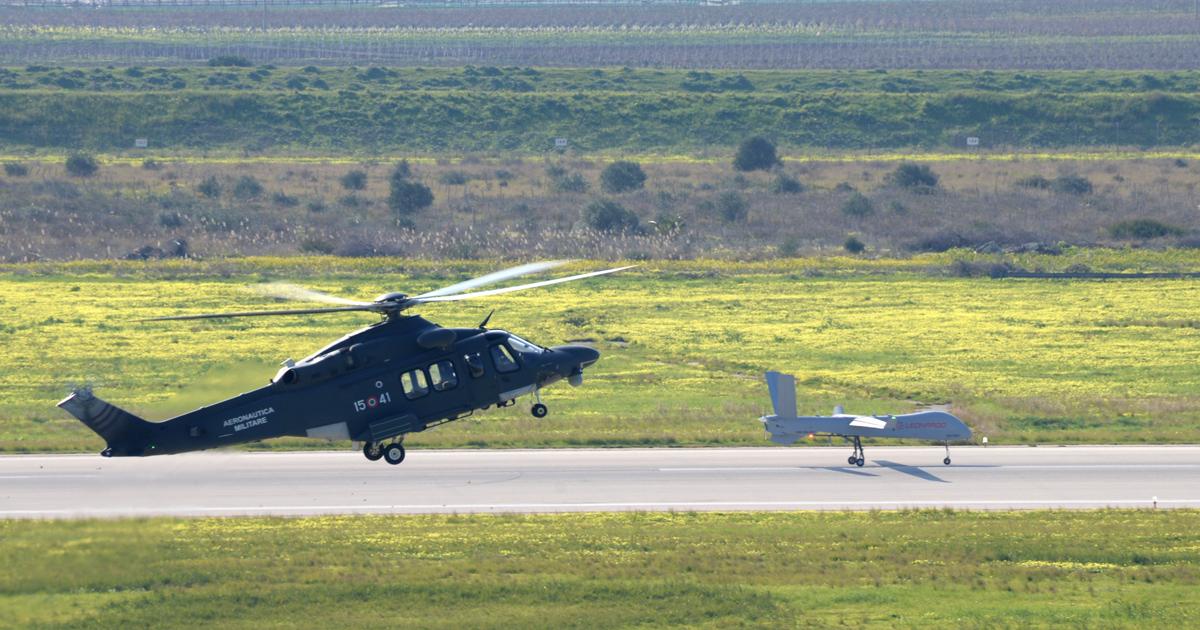 With an Italian air force HH-139A in attendance, the first Falco Xplorer prepares to launch on its maiden flight from the Trapani flight test center on January 15. (photo: Leonardo)
