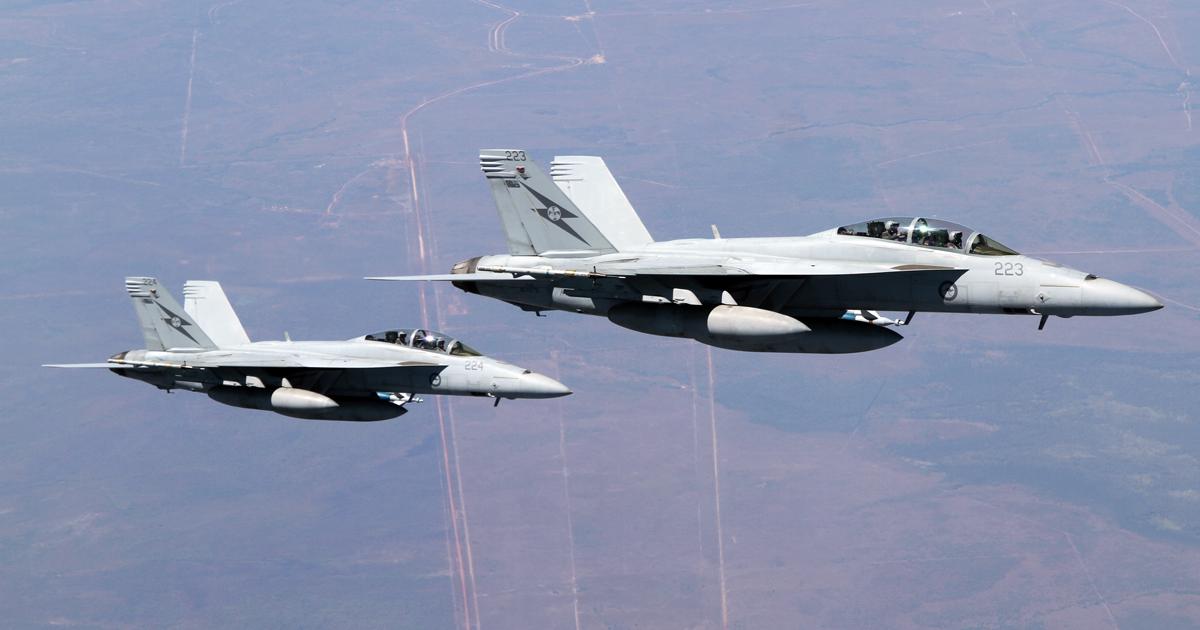A pair of No. 1 Squadron F/A-18Fs is seen during the multi-national Pitch Black exercise held in northern Australia. The aircraft carry inert laser-guided bombs. (Photo: Nigel Pittaway)