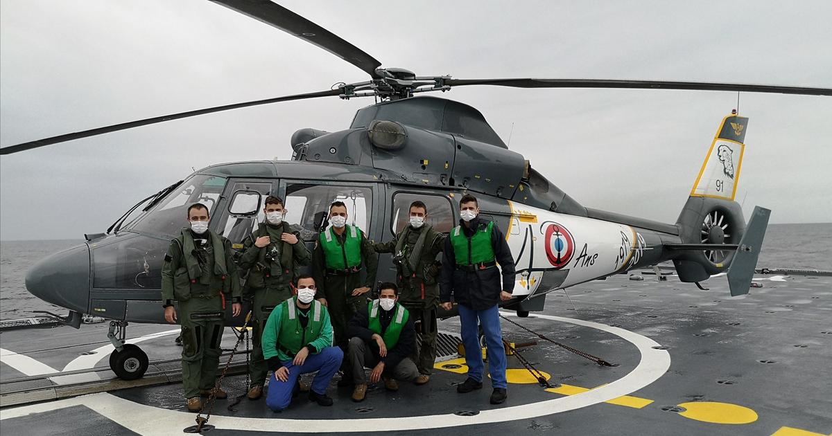 A French navy Flottille 35F crew poses with one of the squadron's six SAR-configured AS 365N helicopters during recent trials aboard the frigate La Fayette. (Photo: Ministère des Armées)