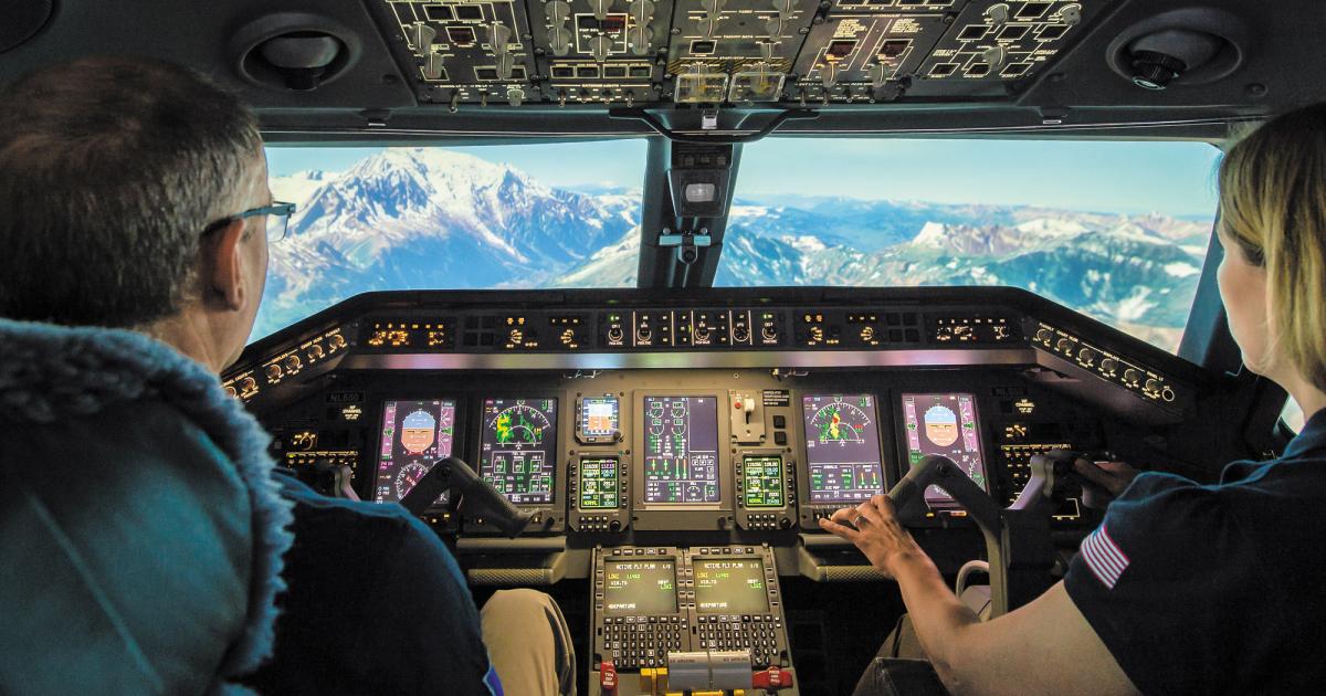 A FlightSafety International Embraer Legacy 650 simulator in pre-pandemic times illustrates the close nature of modern flight training. FlightSafety, like other providers, has had to adjust its operations to meet health guidelines. 