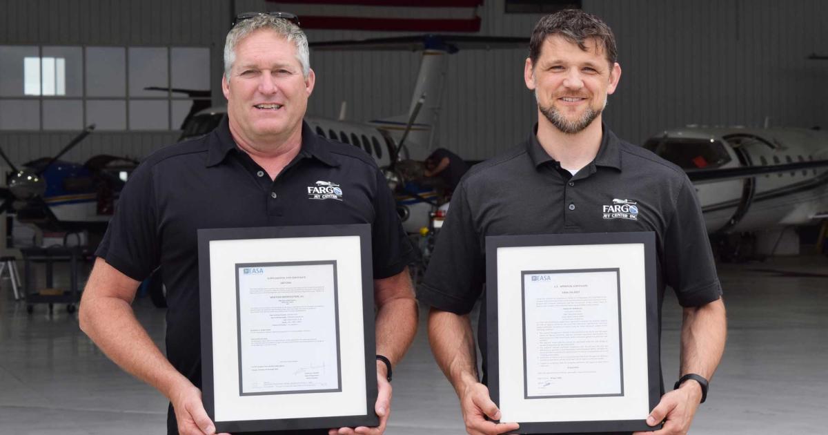 Mike Clancy (L), Fargo Jet Center's v-p of technical services and Josh Rychener, the company's chief inspector, display the maintenance division's recently received EASA Part 145 approval certificates.