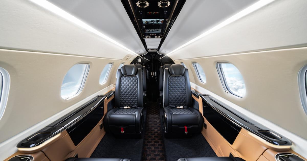 Piano black finishes, gold trim, and carbon fiber accents are among the features of Embraer's Bossa Nova cabin in its enhanced Phenom 300E. (Photo: Embraer)