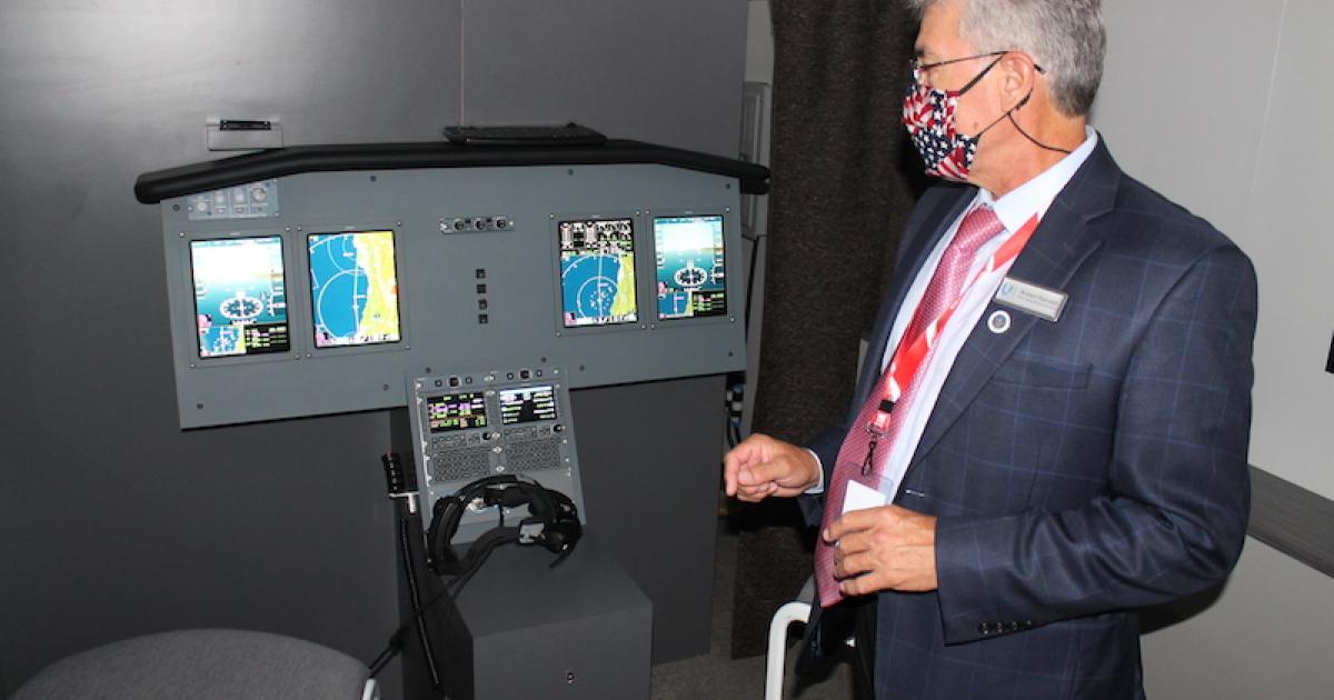 Universal Avionics director of strategic business development Robert Randall explains the features of the company's Mobile Demo Unit during a recent stop at Global Aviation Technologies in Wichita. (Photo: AIN/Jerry Siebenmark)