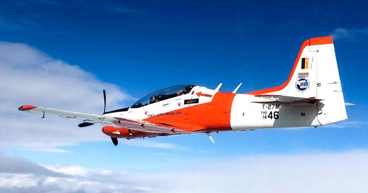 The first Embraer Tucano T-27M is seen from the chase aircraft during its maiden flight. The first of two pattern aircraft for evaluation is a former AT-27 light attacker. (Photo: PAMA LS)