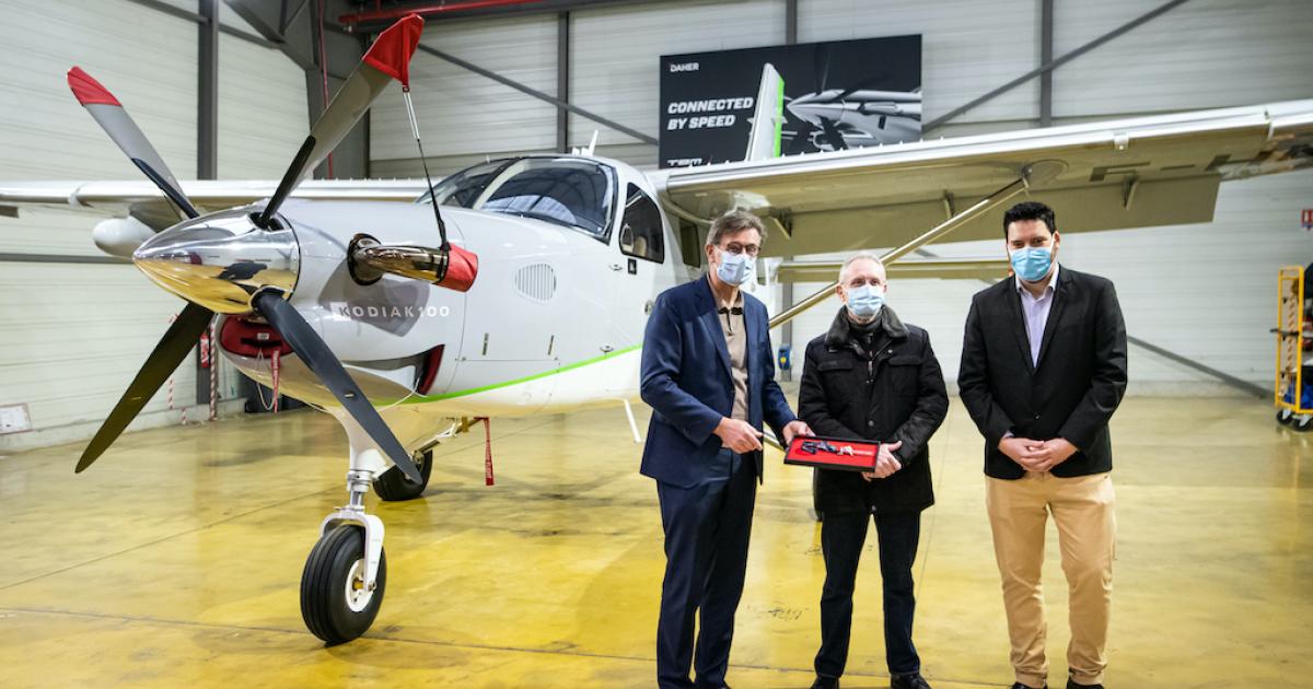 Nicolas Chabbert, senior v-p of Daher’s aircraft division and CEO of Kodiak Aircraft, left, hands over a Kodiak 100 to Héli-Béarn CEO Jean-Luc Dartiailh, with Hugo Delpi, Daher aircraft sales director for Europe, the Middle East, and Asia, also attending the delivery ceremony. (Photo: Daher)