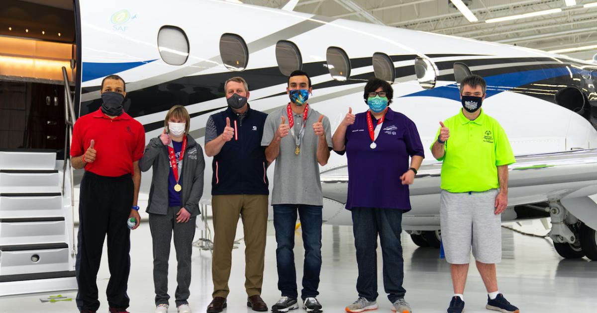 Textron Aviation president and CEO Ron Draper, third from left, poses with Special Olympics athletes next to a Cessna Citation Longitude. (Photo: Textron Aviation)