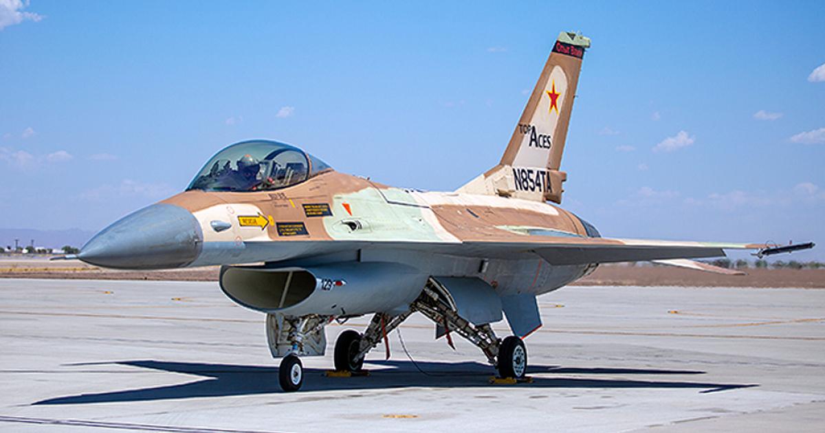 Seen on the ramp at Mesa-Gateway where overhaul and upgrade are performed, Top Aces’ first F-16A still wears its Israeli air force camouflage. (Photo: Top Aces Corp.)