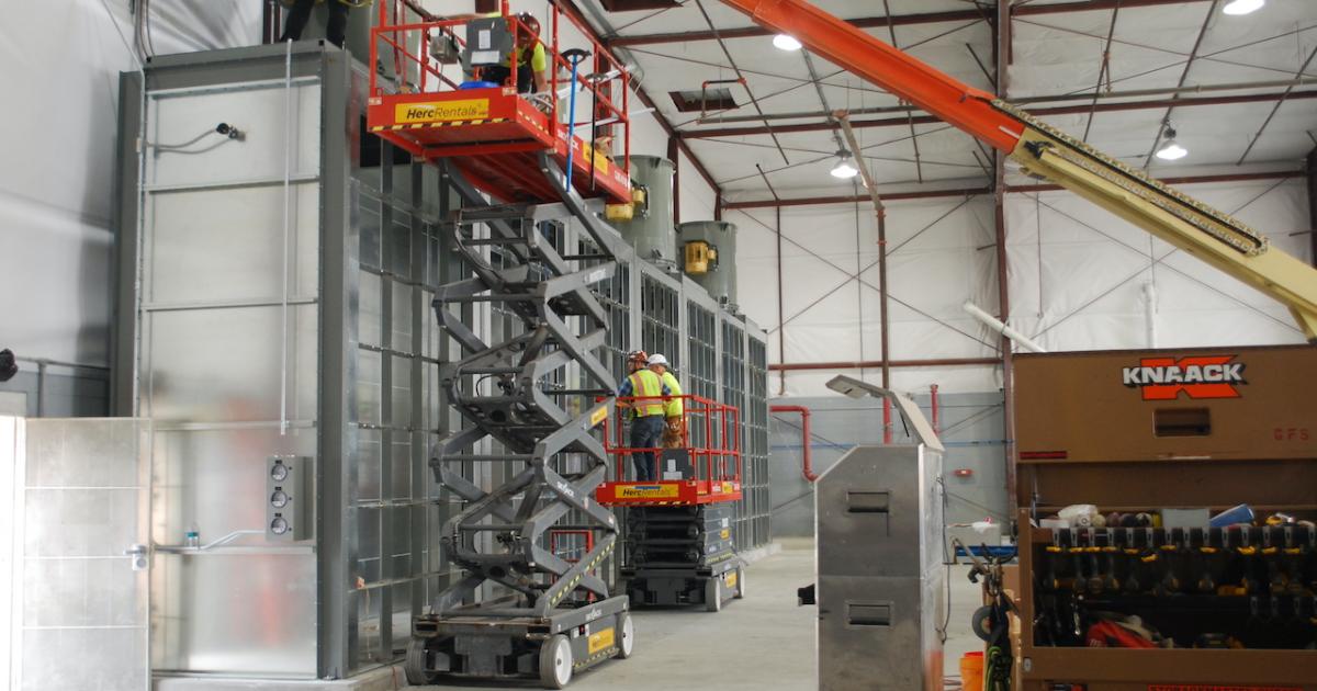 Workers install the ventilation system for a larger paint operation at Constant Aviation's MRO facility at Orlando Sanford International Airport. (Photo: Constant Aviation)