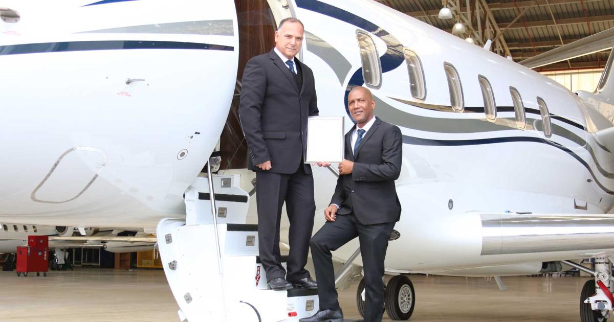 ExecuJet MRO Services’ Vince Gonclaves, v-p for Africa, and Eldred de Villiers, regional sales manager for Africa, hold their facility's FAA Part 145 certificate. (Photo: ExecuJet MRO Services)