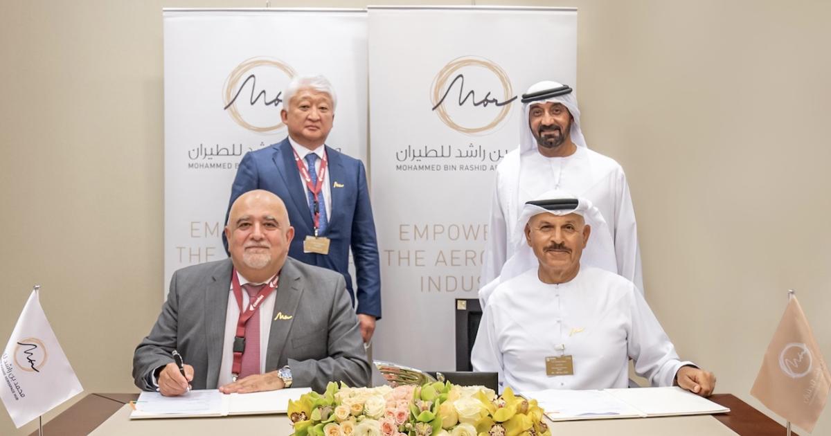Richard Gaona, executive chairman and CEO of Comlux (bottom left) signs agreement with HE Khalifa Al Zaffin, executive chairman of Dubai Aviation Corporation (bottom right), in the presence of His Highness Sheikh Ahmed bin Saeed Al Maktoum, president of the Dubai Civil Aviation Authority, chairman and chief executive of Emirates Airlines, and chairman of Dubai Airports (top right) and Comlux's Vladimir Kim (Photo: Comlux).