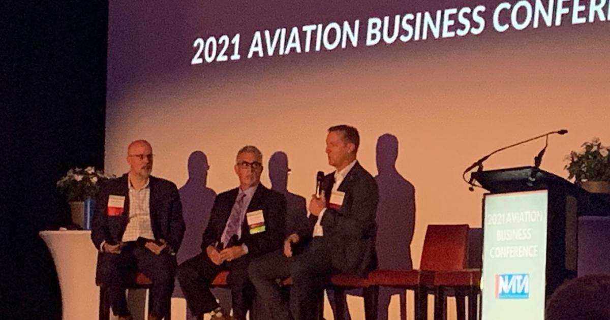 (L-r):  Aviation Management Consulting Group managing principal Aerolease/Aeroplex Group president and CEO Jeff Kohlman, and Clay Lacy Aviation senior v-p of operations Scott Cutshall discuss infrastructure issues for electric aircraft. (Photo: Kerry Lynch/AIN)