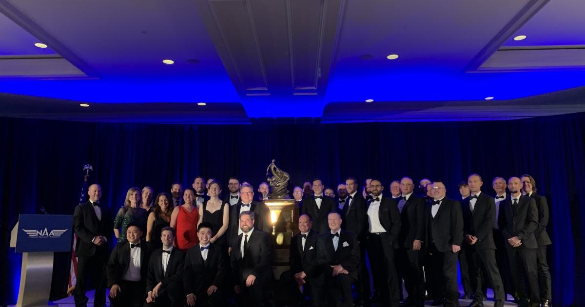 The Garmin team poses next to the Collier Trophy, awarded for 2020 for the Garmin Autoland system. (Photo: Matt Thurber/AIN)