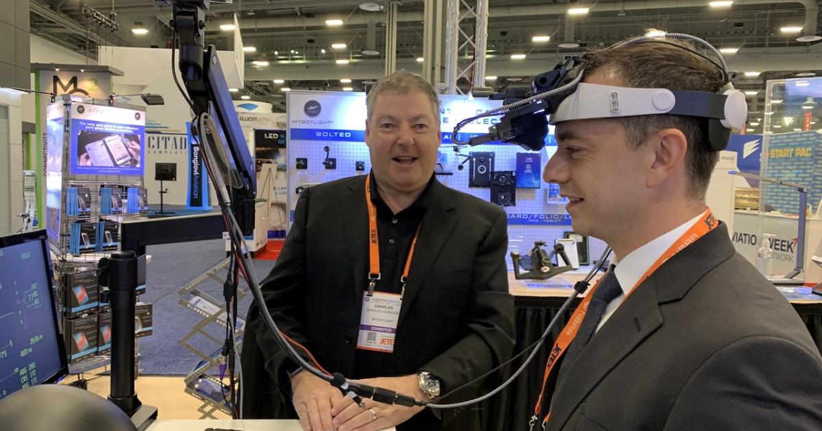 After receiving FAA certification for his MyGoFlight HUD, Charlie Schneider brought his newest invention, a low-cost head-wearable display, to last year's NBAA-BACE, where he proudly demonstrated it to attendees. (Photo: Matt Thurber/AIN)