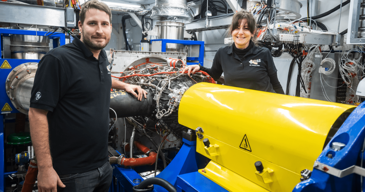 Test engineer Josef Toman and lead test engineer Stefania Tinu pose with the Catalyst engine inside the Dyno test cell in Prague as the team embarks on SAF research. (Photo: GE Aviation)