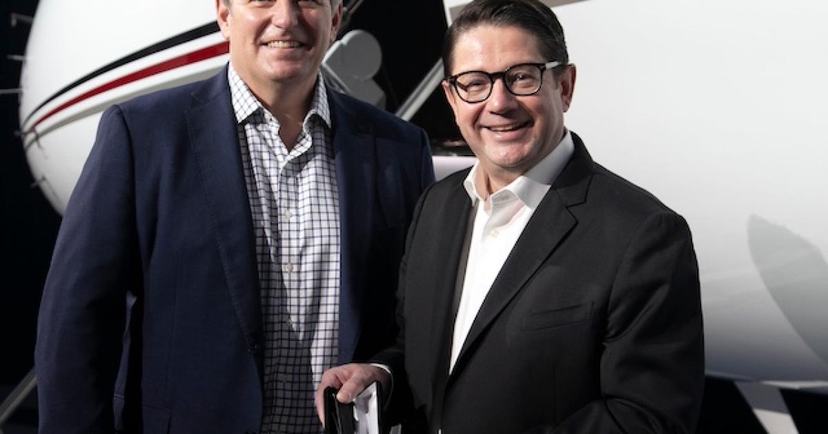 Patrick Gallagher, NetJets president of sales, marketing, and services, receives the key to the Global 7500 from Éric Martel, Bombardier president and CEO. (Photo: Bombardier)