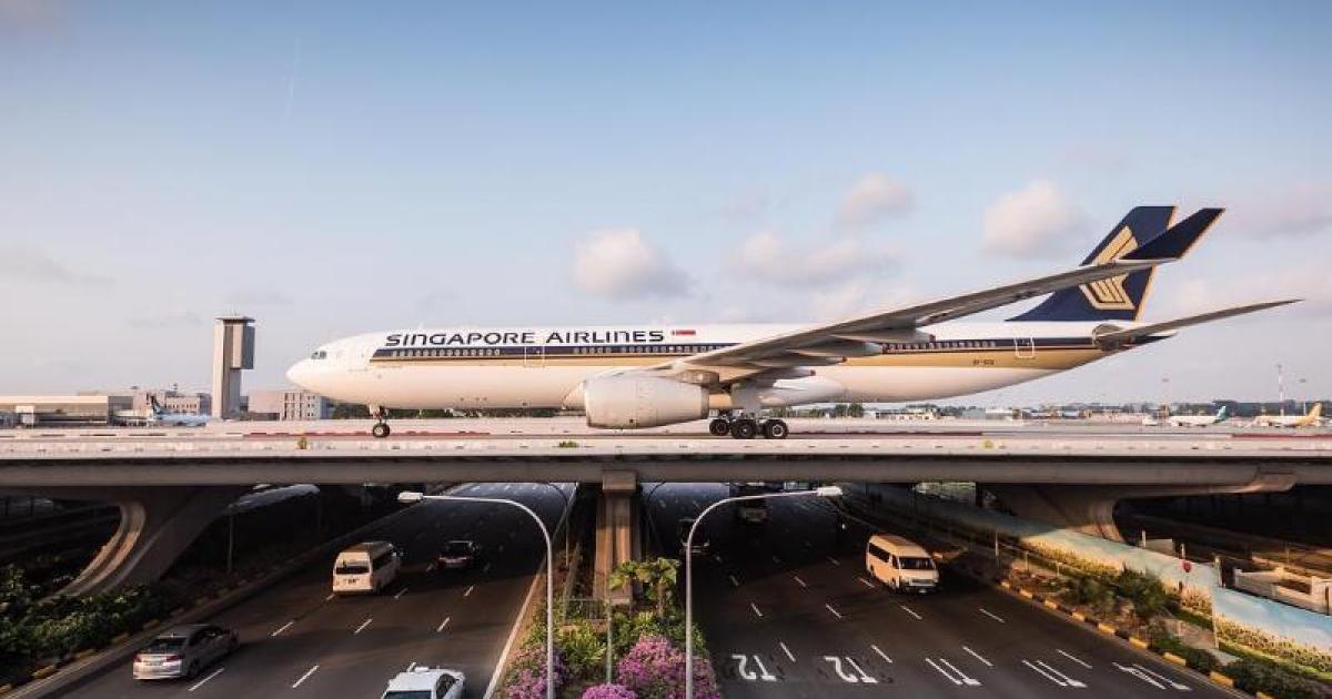 A Singapore Airlines Airbus A330 crosses Changi Airport's Southcross Bridge over Airport Boulevard. 
