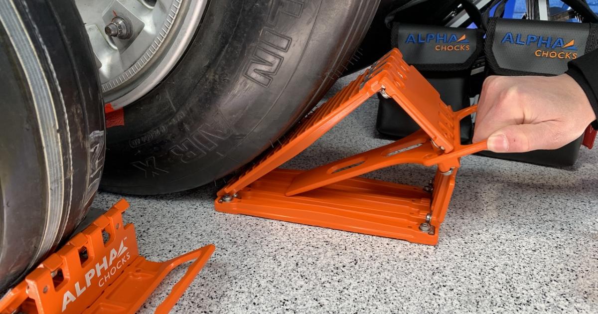 Pull on the handle of an Alpha Chocks and it collapses for easy removal without getting stuck against the tire. (Photo: Matt Thurber/AIN)