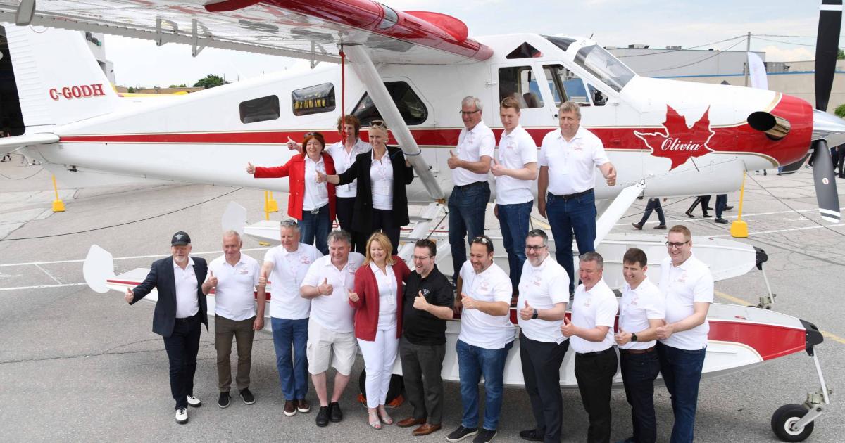 De Havilland Aircraft of Canada employees and retirees gather next to a 1956 De Havilland Canada DHC-2T Viking Turbo Beaver at a celebration held on June 11, 2022, marking 93 years at Toronto Downsview Airport before moving company offices to nearby Pearson Airport. (Photo: Kenneth Swartz)